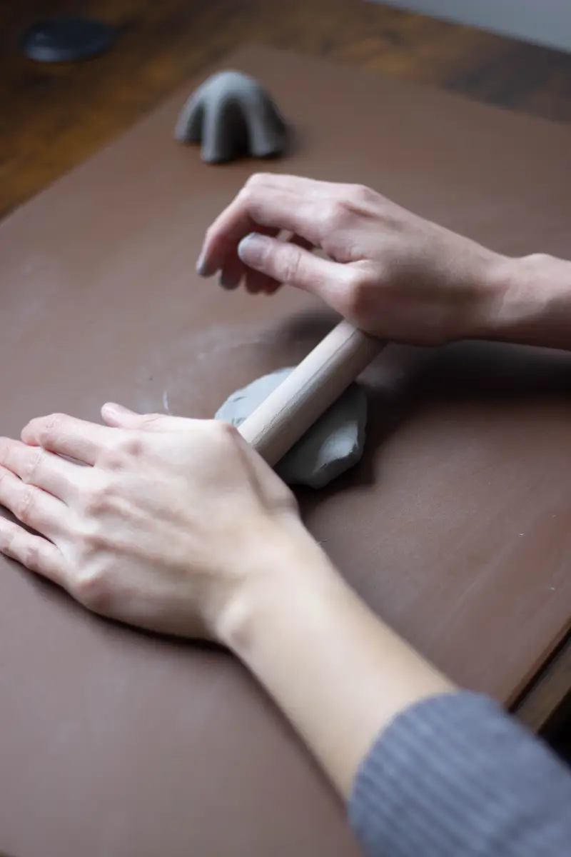 Aplatir l'argile uniformément grâce à un rouleau à pâtisserie