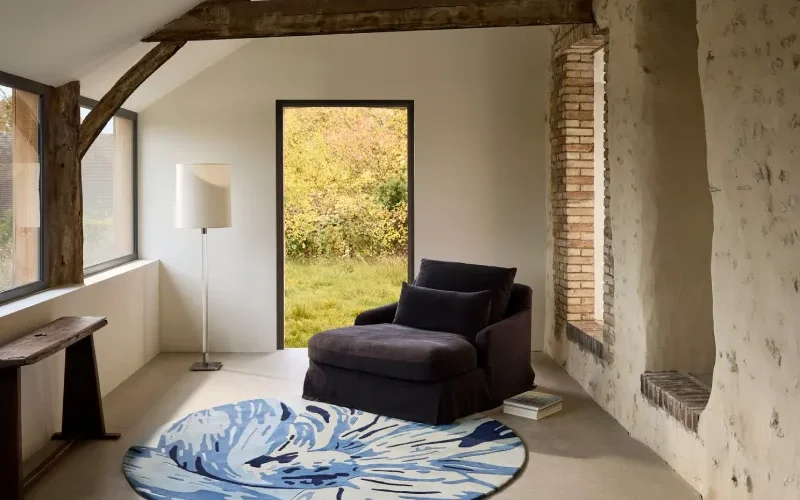 Choisir un tapis adapté à son intérieur, tapis rond à motifs bleus sous un fauteuil