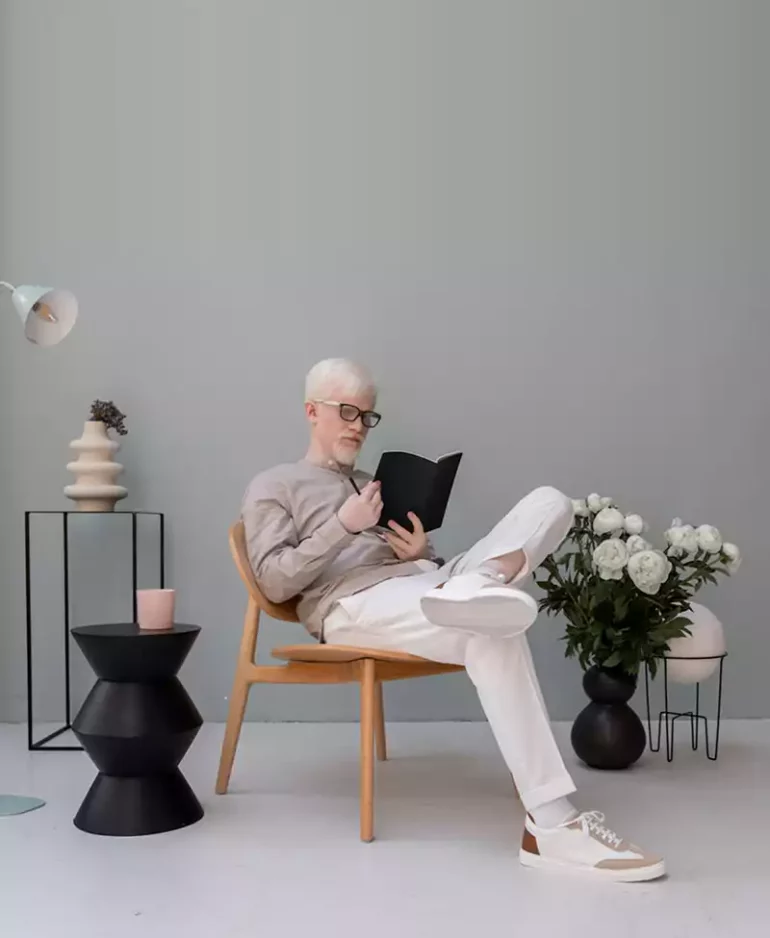 Homme qui lit au milieu d'objets déco