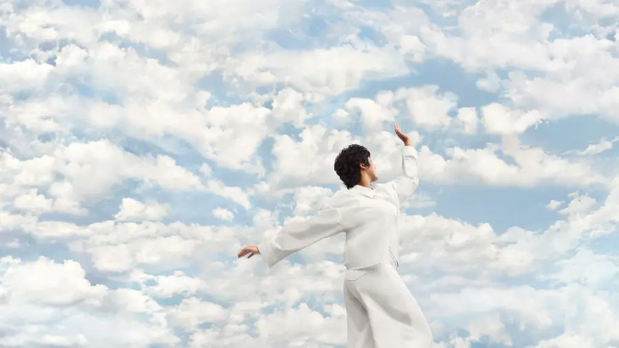 Inspiration ciel de nuages avec une personne aux vêtements couleur Cloud Dancer